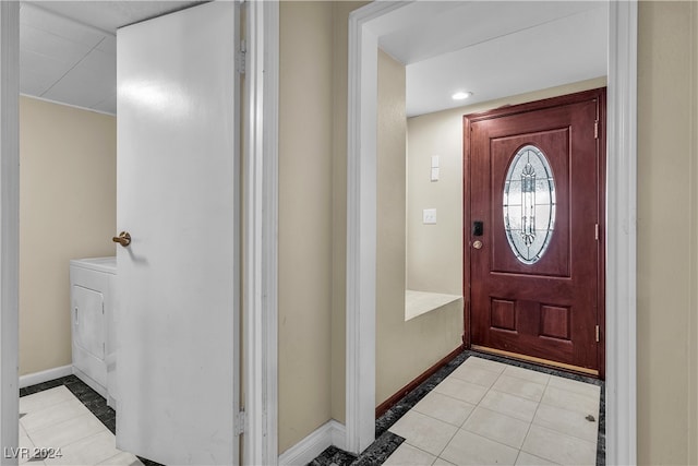 tiled foyer entrance with washer / clothes dryer