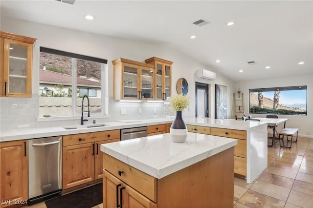 kitchen with plenty of natural light, a kitchen island, and sink