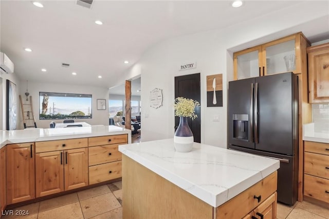 kitchen featuring a kitchen island, stainless steel fridge, vaulted ceiling, decorative backsplash, and light tile patterned floors