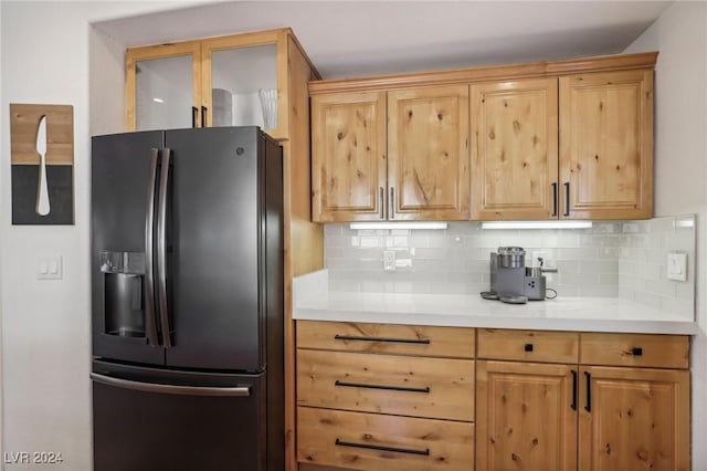 kitchen with decorative backsplash and stainless steel fridge with ice dispenser