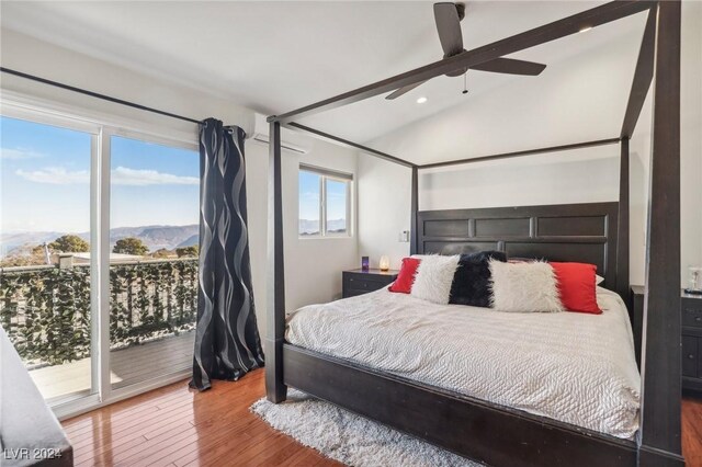 bedroom with a mountain view, lofted ceiling, access to outside, hardwood / wood-style flooring, and ceiling fan