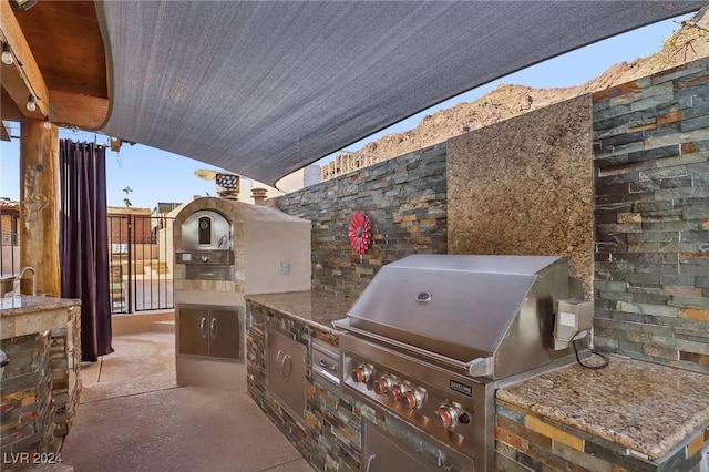 view of patio with grilling area and exterior kitchen