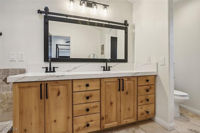 bathroom with tile patterned floors, vanity, and toilet