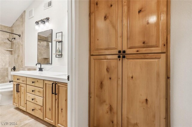 bathroom featuring tile patterned flooring, vanity, and toilet