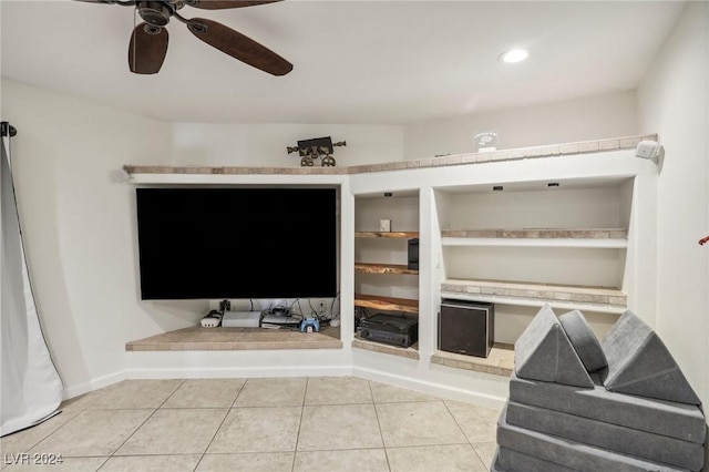 tiled living room with ceiling fan