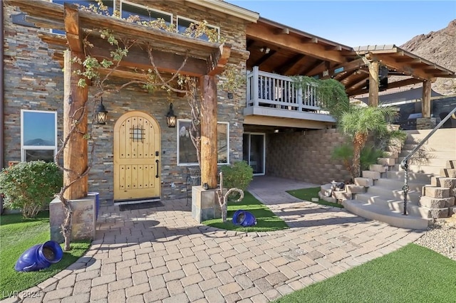 doorway to property featuring stone siding