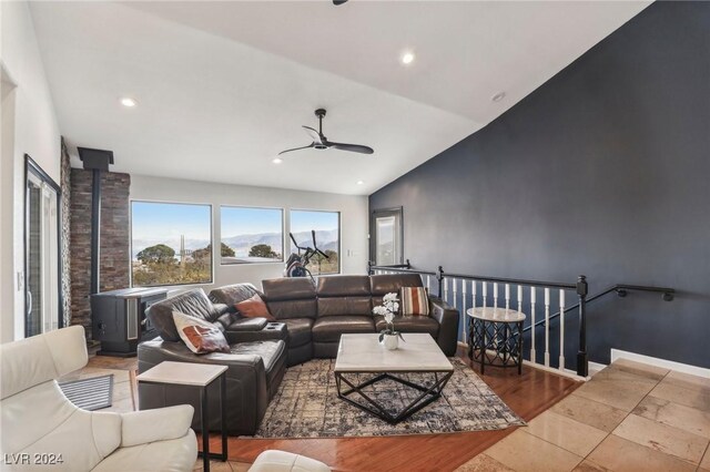 living room featuring vaulted ceiling and ceiling fan