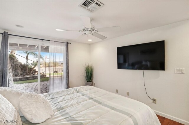 bedroom featuring access to exterior, ceiling fan, and dark wood-type flooring