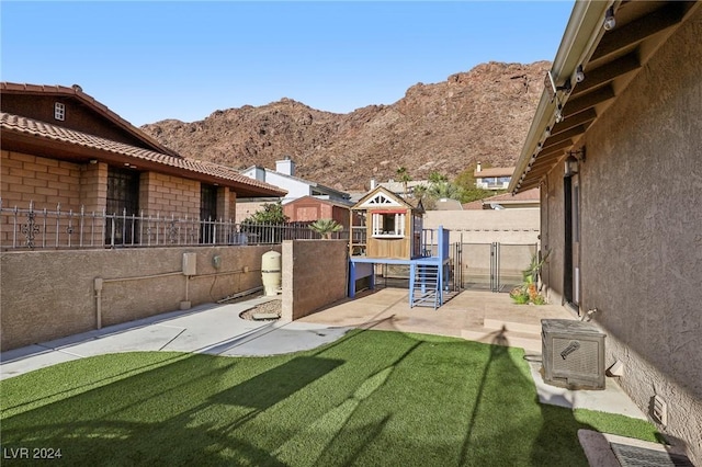 view of yard with a mountain view and a playground