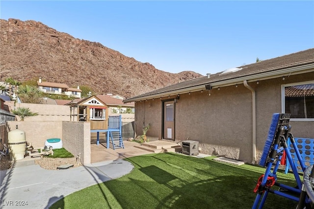 view of yard with a playground, a patio area, and a mountain view