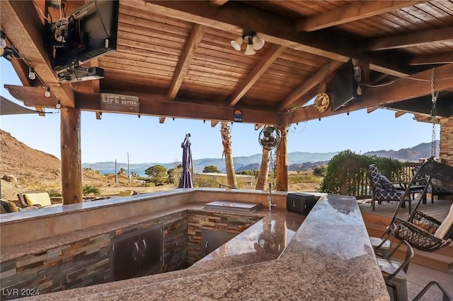 view of patio / terrace featuring a mountain view, a gazebo, and exterior kitchen