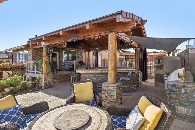 view of patio / terrace featuring an outdoor bar and exterior kitchen