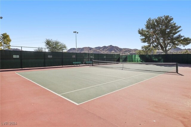 view of tennis court with a mountain view