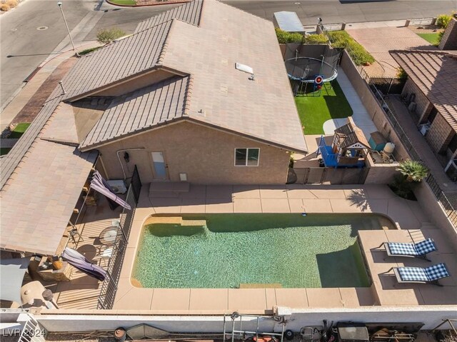 view of swimming pool featuring a trampoline