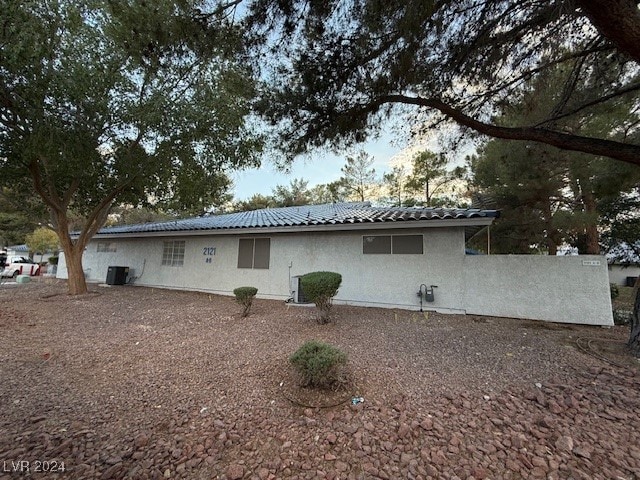 rear view of property featuring cooling unit