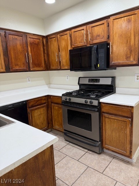 kitchen featuring gas stove and light tile patterned floors