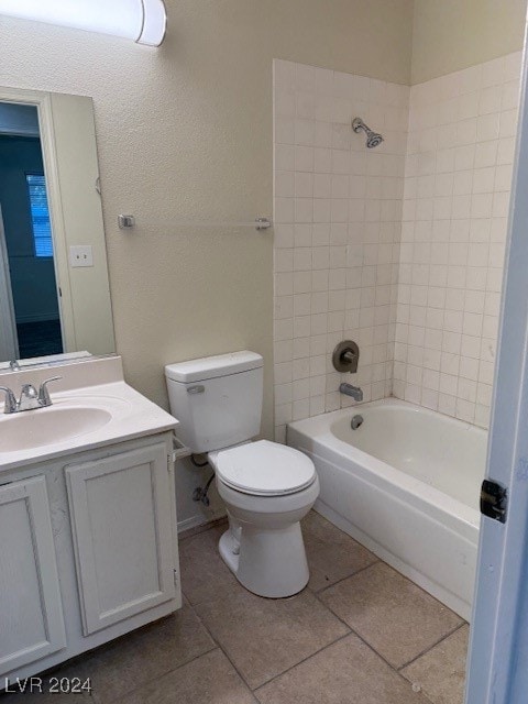 full bathroom featuring vanity, toilet, tile patterned flooring, and tiled shower / bath