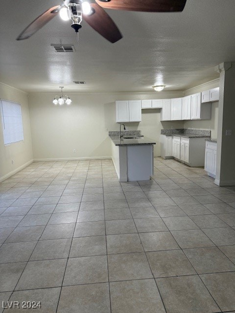 kitchen with sink, white cabinetry, ceiling fan, and light tile patterned floors