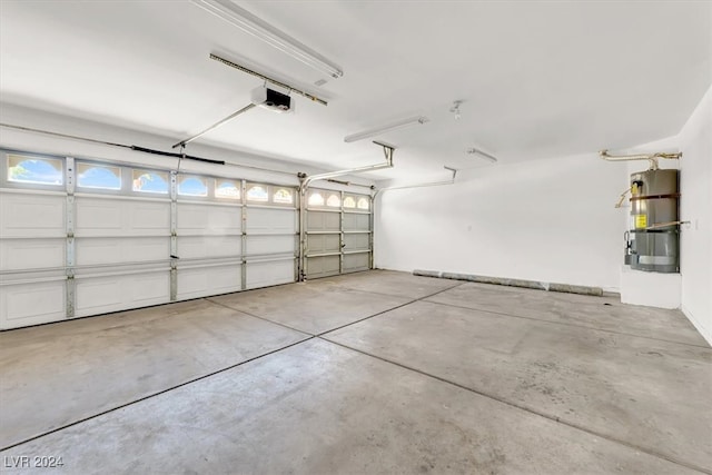 garage featuring a garage door opener and secured water heater