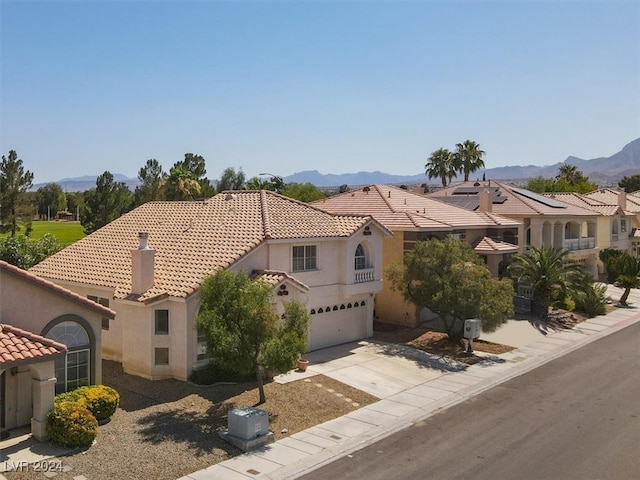 mediterranean / spanish-style home featuring a mountain view and a garage