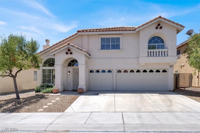 mediterranean / spanish-style house with a garage