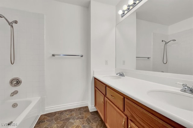 bathroom with vanity and tiled shower / bath