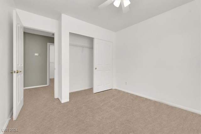 unfurnished bedroom featuring a closet, ceiling fan, and light carpet