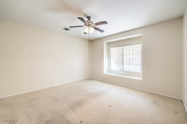 empty room featuring carpet flooring and ceiling fan