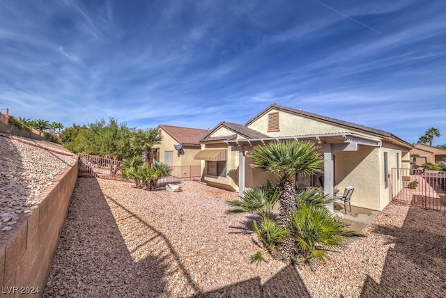 view of property exterior with a patio area