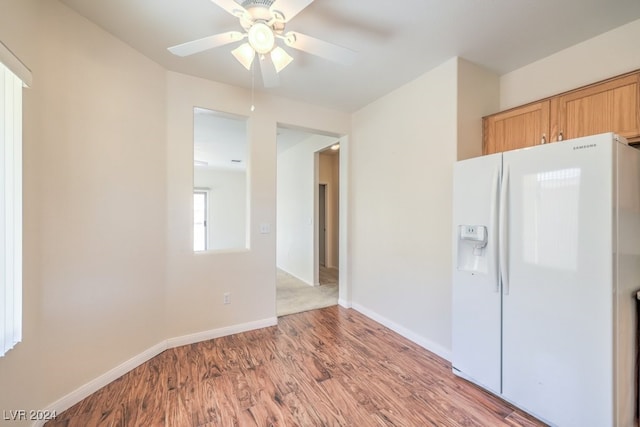 kitchen with white refrigerator with ice dispenser, light brown cabinets, light wood-type flooring, and ceiling fan