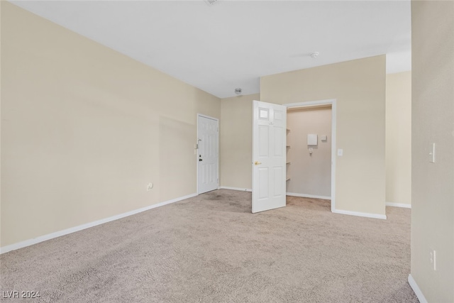 unfurnished bedroom with light colored carpet