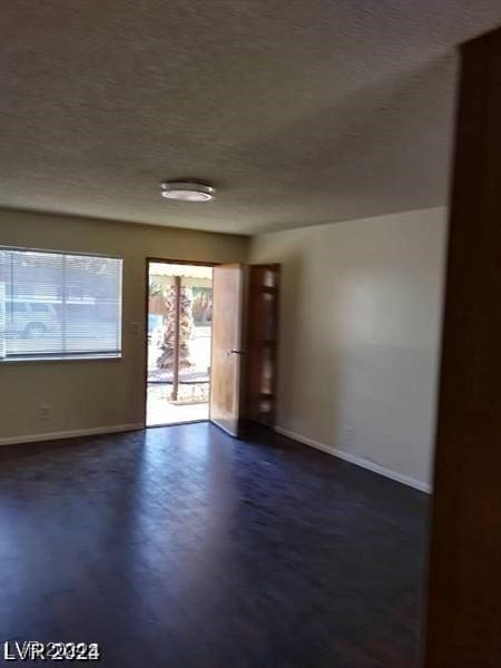 spare room featuring dark hardwood / wood-style floors