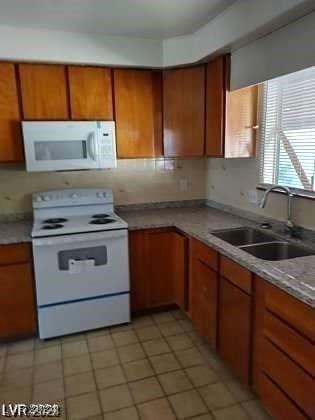 kitchen with sink and white appliances