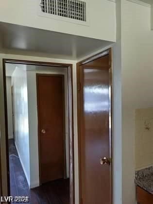 hallway featuring dark hardwood / wood-style flooring