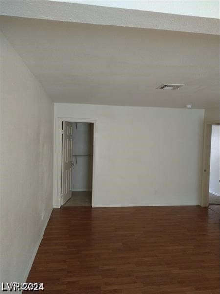 empty room with dark wood-type flooring