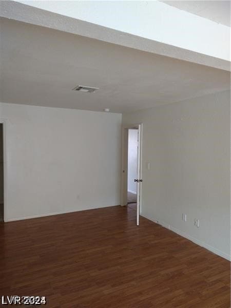 unfurnished room featuring dark hardwood / wood-style flooring