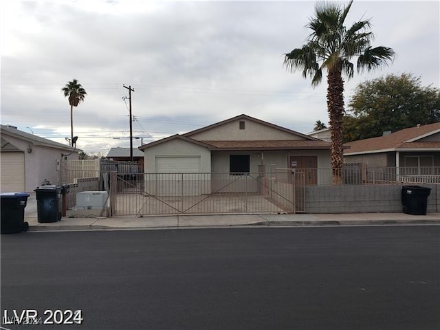 1929 Evelyn Ave, Henderson, NV 89011 - ranch-style house with a garage, a gate, concrete driveway, and stucco siding