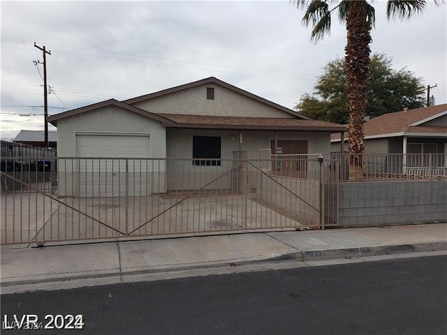 1929 Evelyn Ave, Henderson, NV 89011 - ranch-style house featuring stucco siding, a fenced front yard, an attached garage, and covered porch