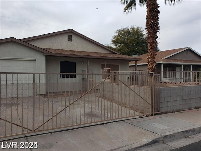 1929 Evelyn Ave, Henderson, NV 89011 - ranch-style house with stucco siding, a fenced front yard, a porch, a garage, and roof with shingles