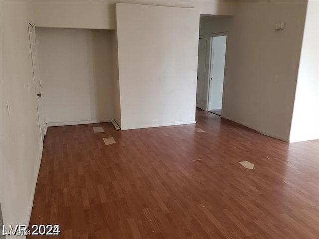 empty room with dark hardwood / wood-style floors