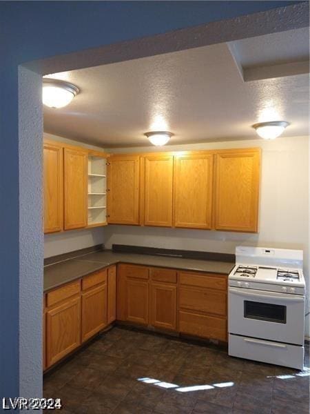 1929 Evelyn Ave, Henderson, NV 89011 - kitchen featuring white range with gas stovetop, dark countertops, and open shelves