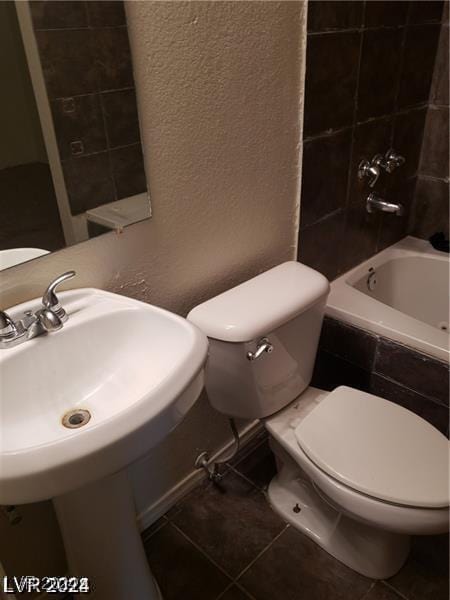 1929 Evelyn Ave, Henderson, NV 89011 - bathroom featuring a textured wall, tiled shower / bath combo, and tile patterned flooring