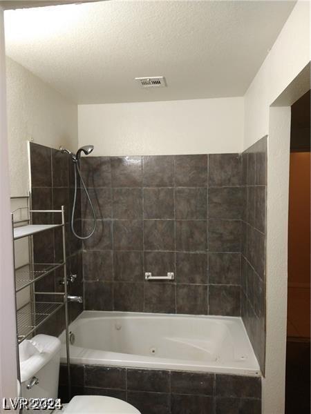 1929 Evelyn Ave, Henderson, NV 89011 - bathroom featuring toilet and tiled shower / bath