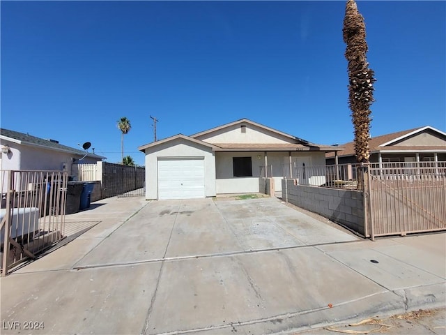 1929 Evelyn Ave, Henderson, NV 89011 - ranch-style home featuring stucco siding, an attached garage, and driveway