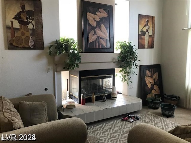 carpeted living room featuring a fireplace