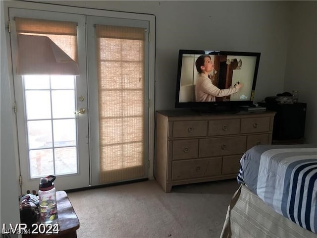 bedroom featuring french doors and light colored carpet