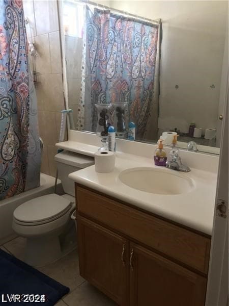 full bathroom with vanity, tile patterned flooring, toilet, and shower / tub combo