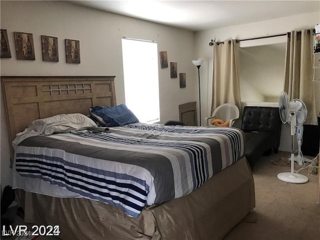 bedroom featuring multiple windows and carpet