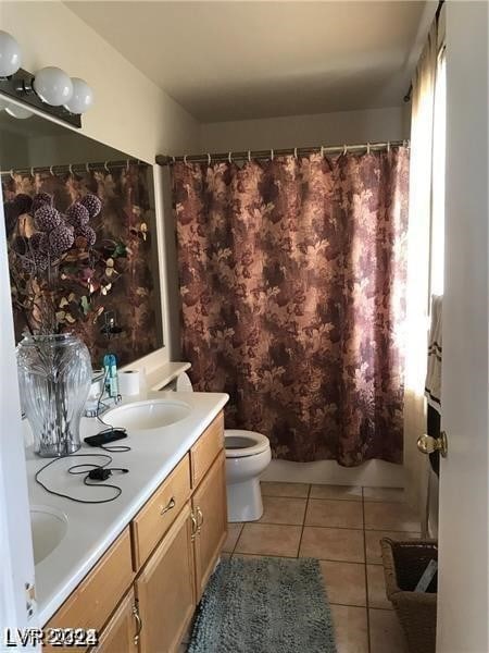 full bathroom with vanity, shower / bathtub combination with curtain, toilet, and tile patterned floors