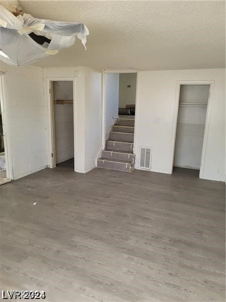 basement with a textured ceiling and hardwood / wood-style flooring